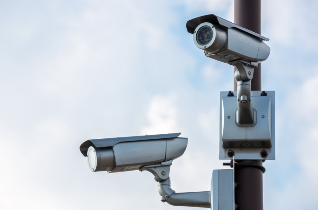 two high tech cctv cameras secured on to street pole