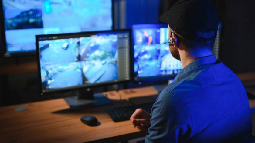 a security operative watches CCTV footage in a remote monitoring centre